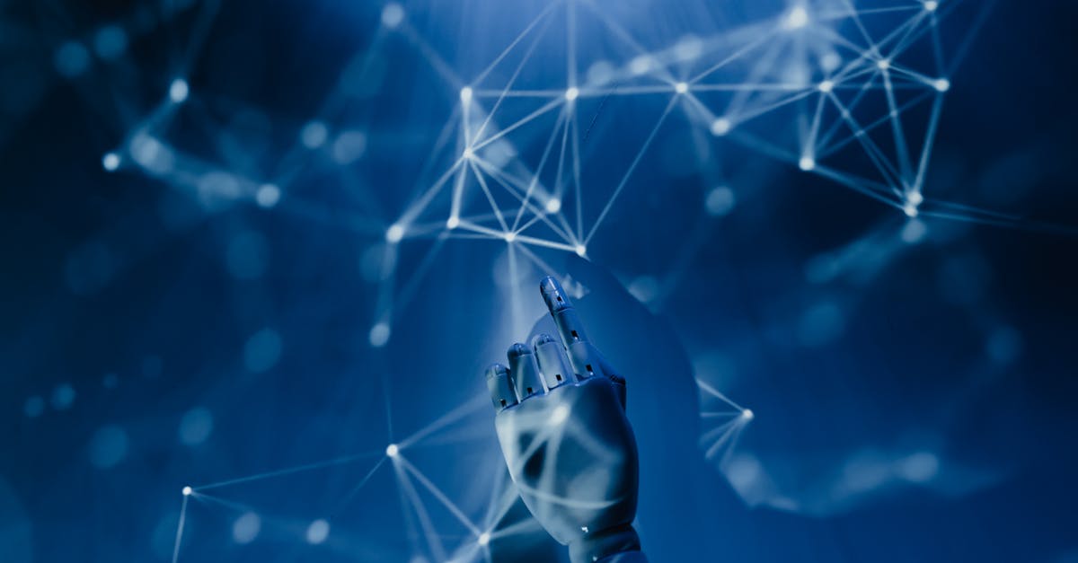 pexels-photo-8386440-8386440 A robotic hand reaching into a digital network on a blue background, symbolizing AI technology.